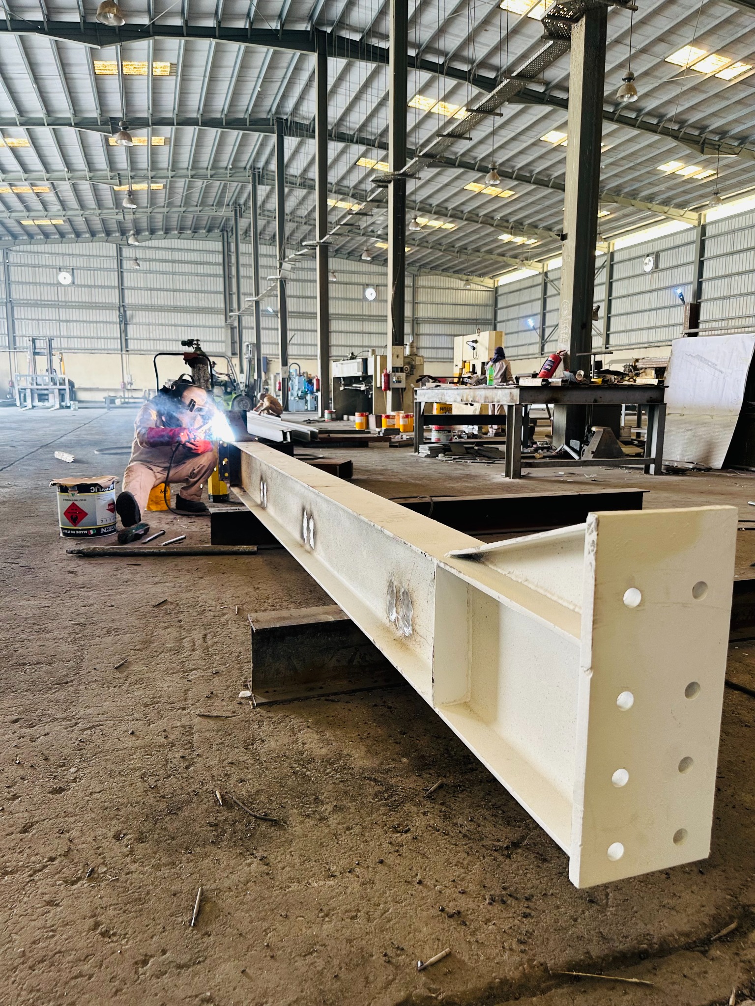 Steel beam under fabrication inside the workshop