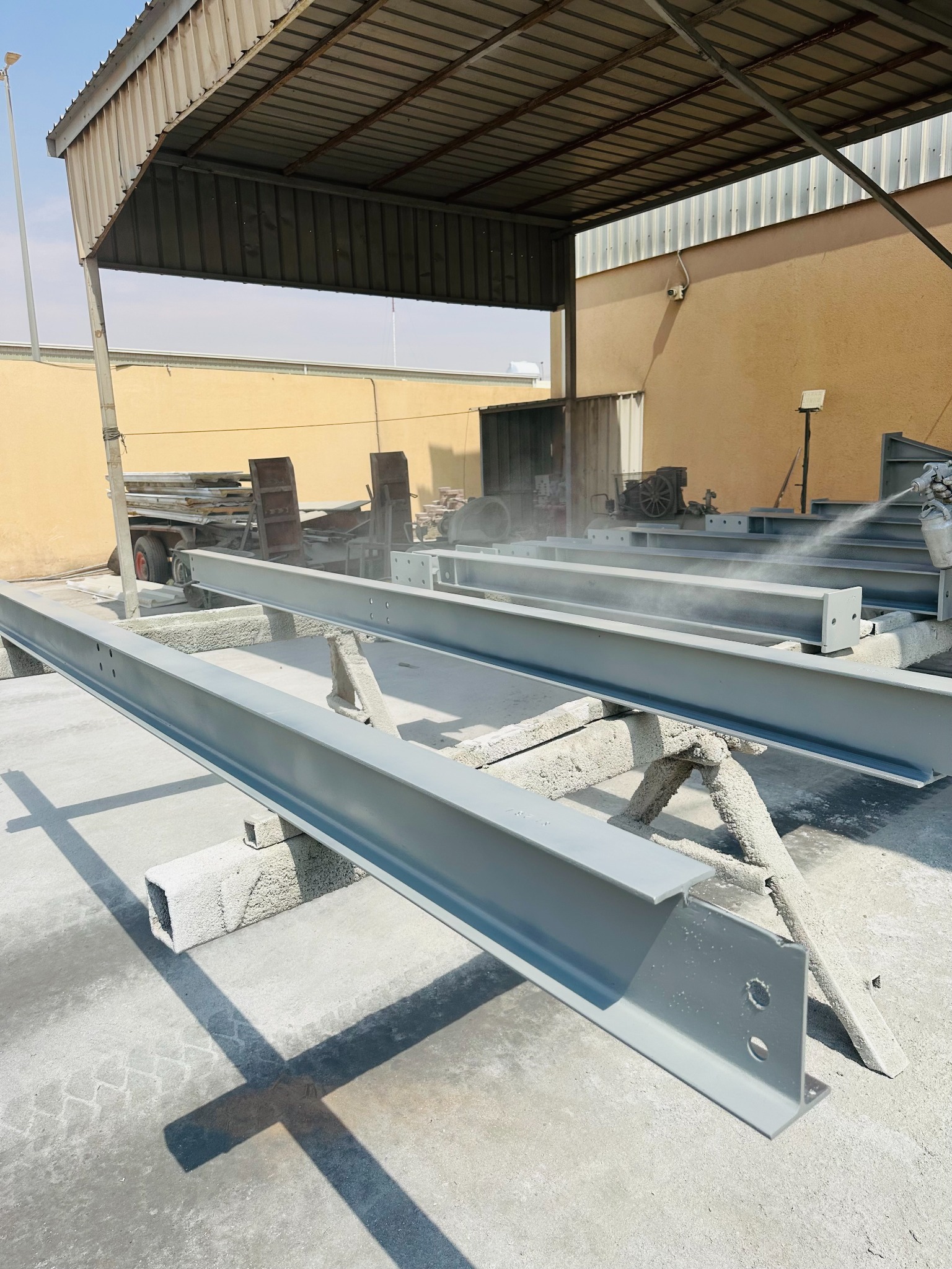 Fabricated steel sections stored outside the workshop