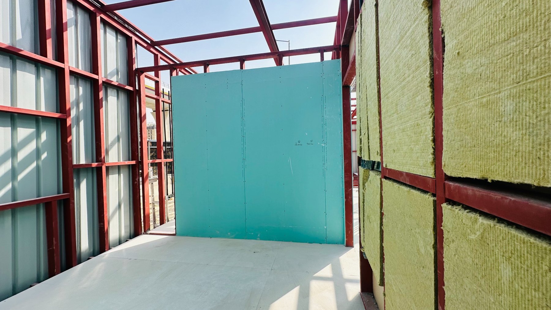 Partition boards and insulation being fitted within a steel frame