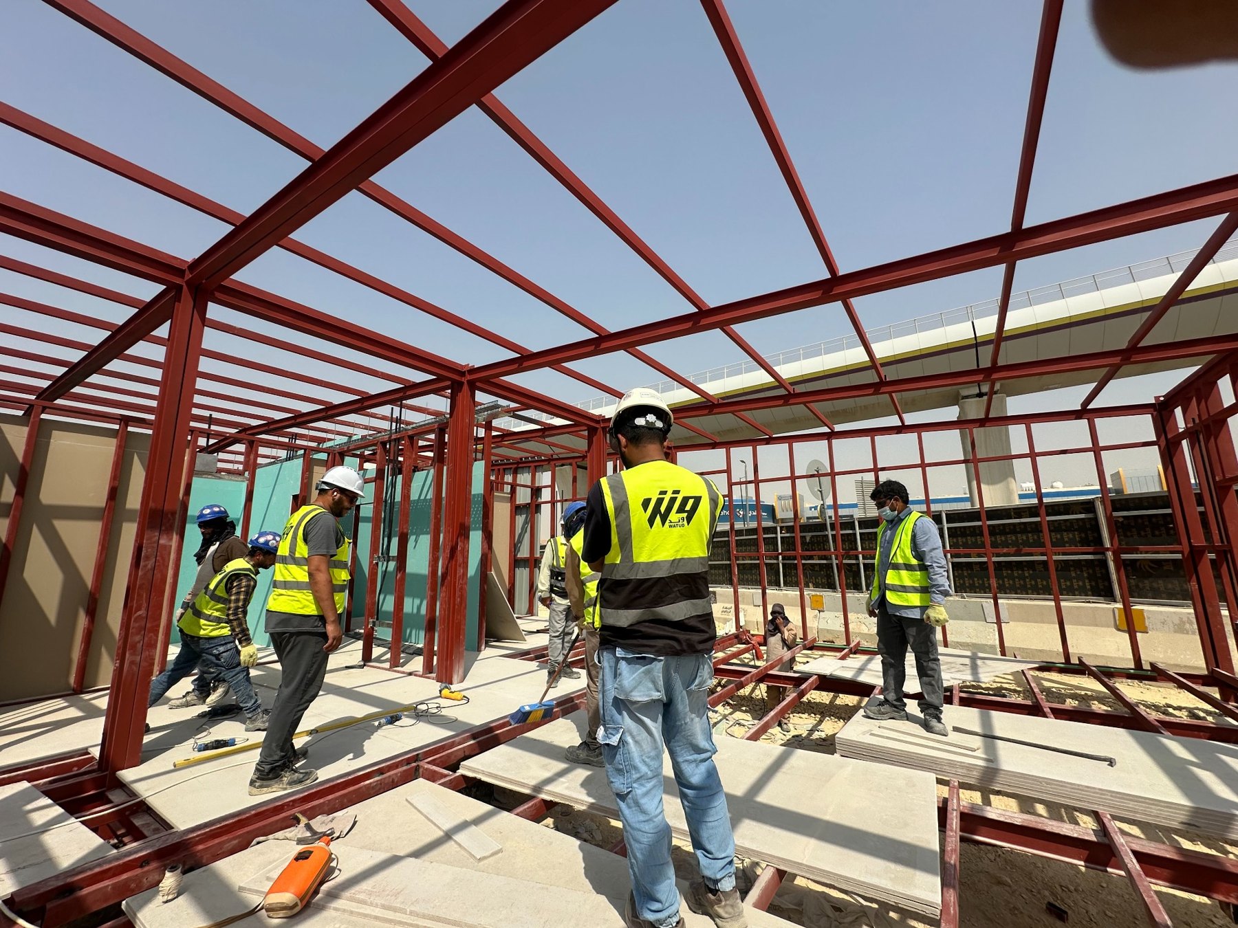 Workers assembling a steel frame on site