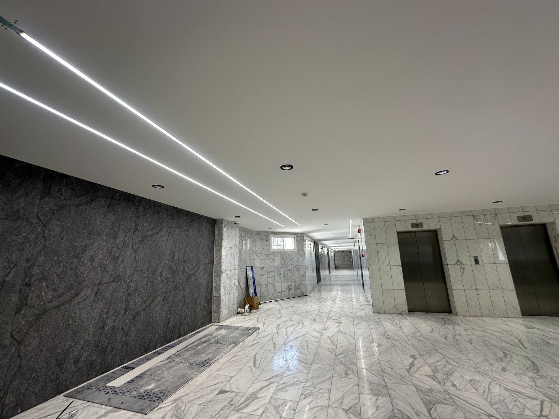 Interior with wall cladding, ceiling lighting and floor finishes