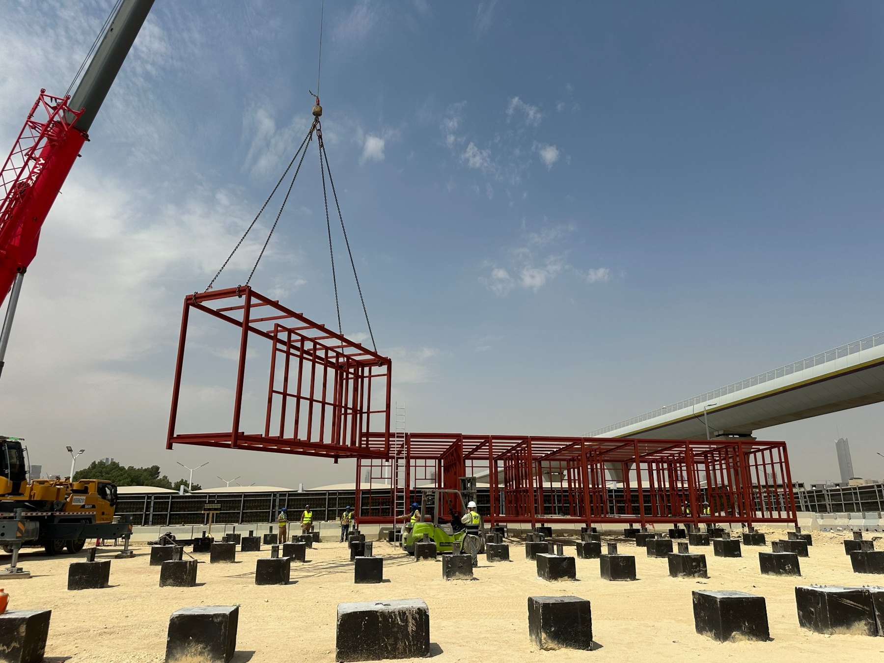 Crane lifting a steel frame into position on site
