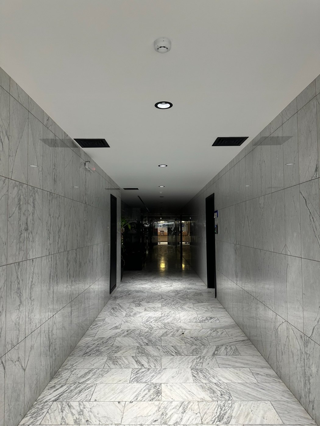 Corridor with wall cladding and ceiling lights